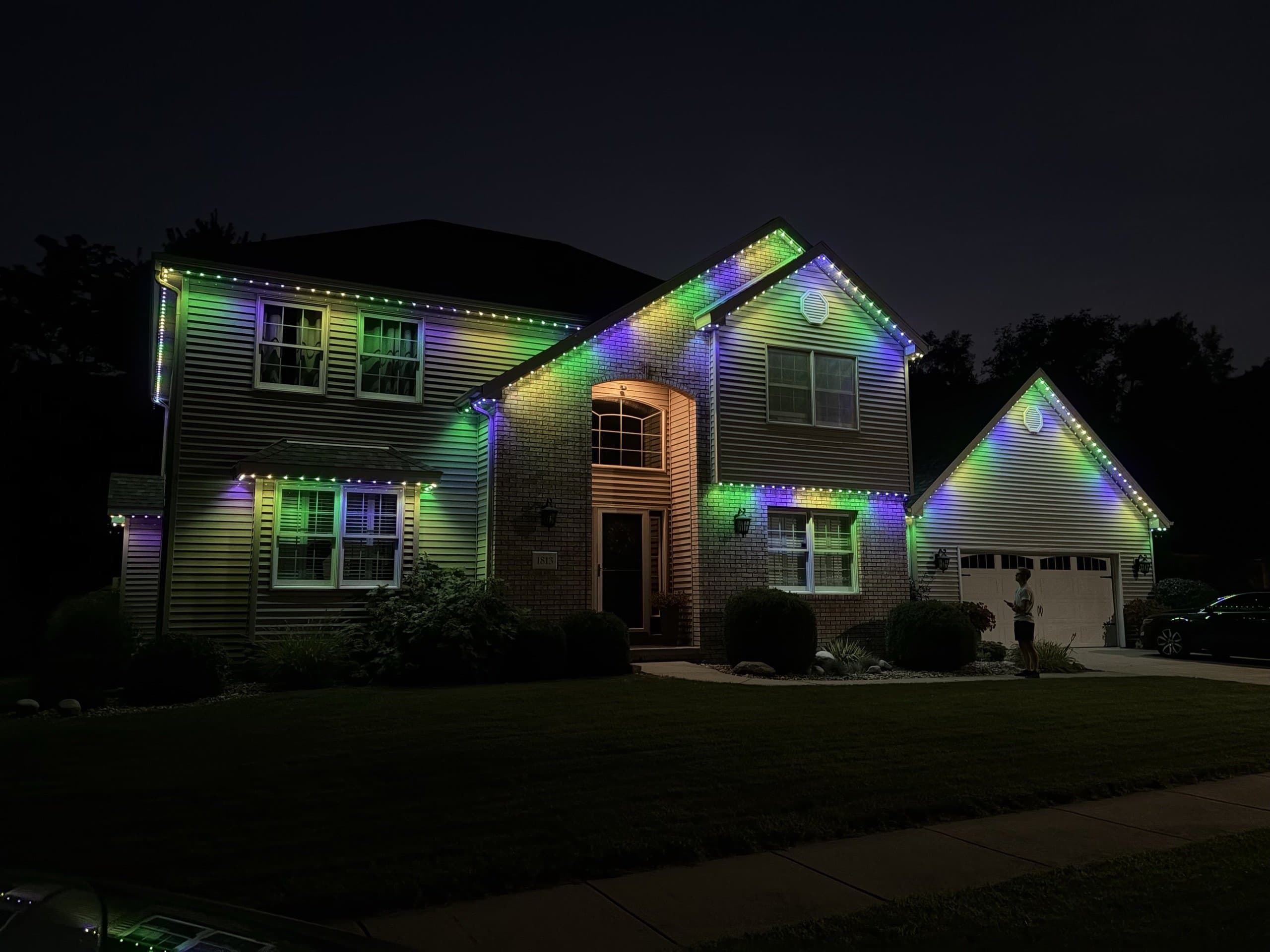 Home lit for the holidays with colorful permanent and festive lighting