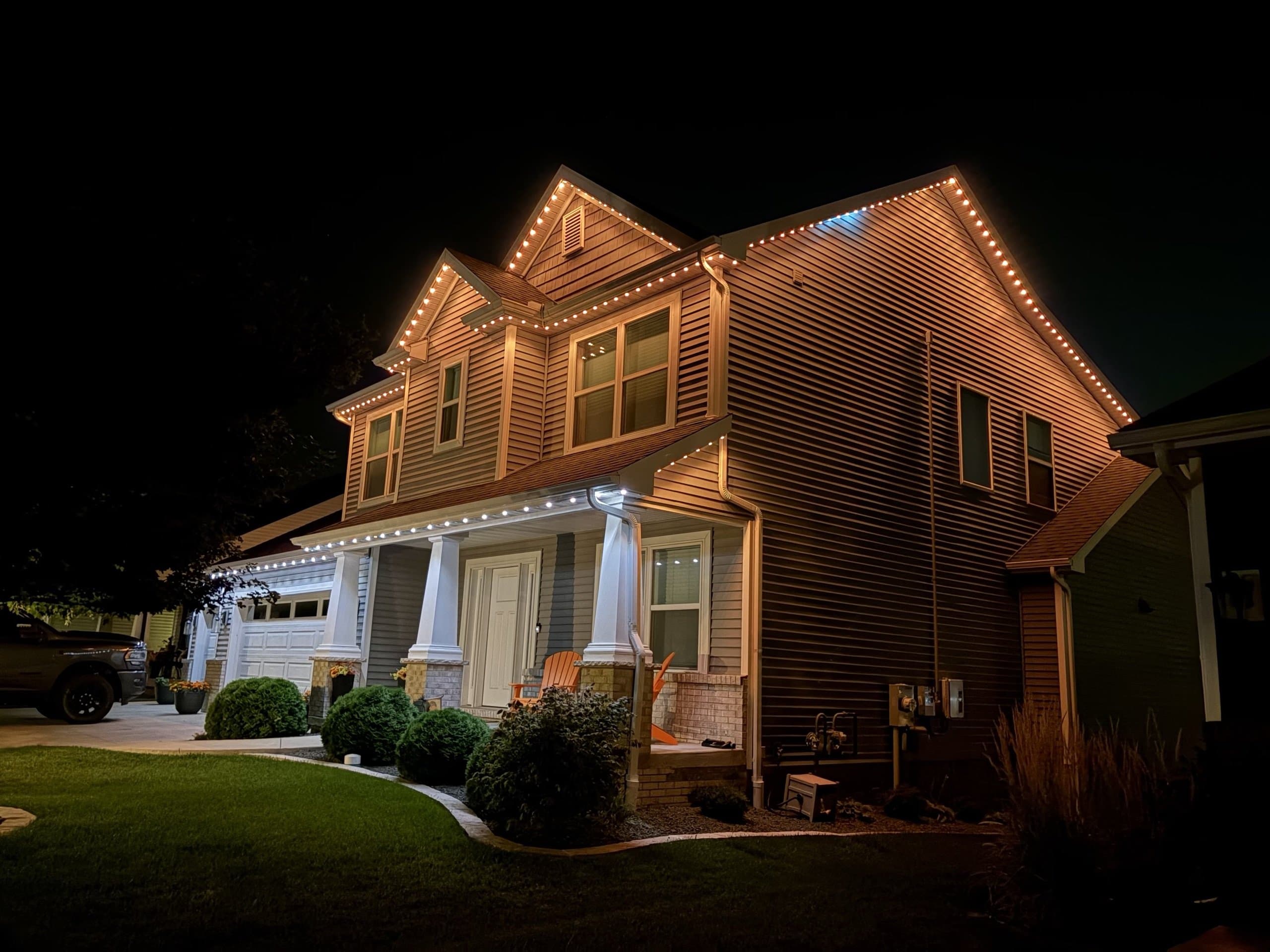 Warm-white outdoor lighting creating a cozy evening ambiance at a home